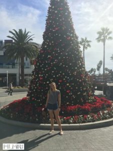 Kelsey by a Christmas tree in Long Beach