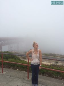 Kelsey in front of the Golden Gate Bridge on a foggy day