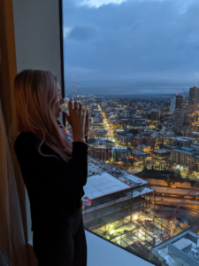 Traveler looking out the window at a dark Seattle morning