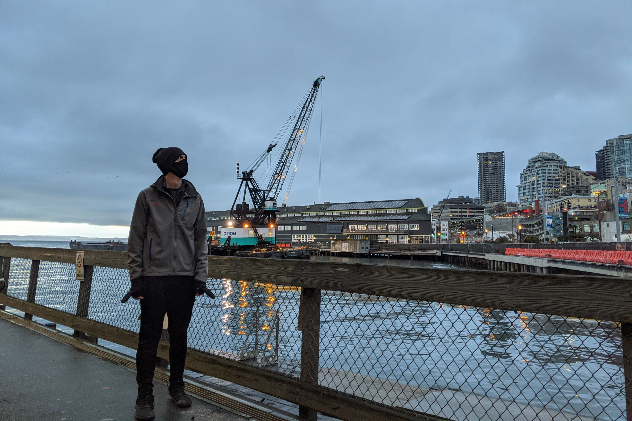 Traveler standing along Seattle's boardwalk early in the morning