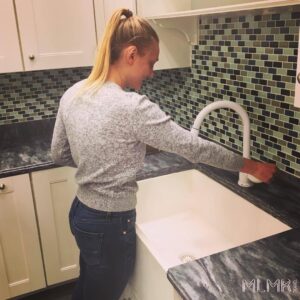 Lady standing in a clutter free kitchen