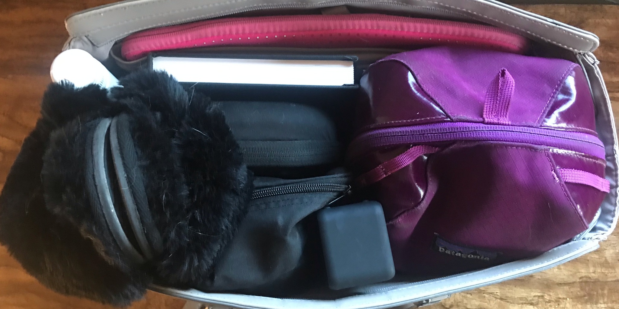 Travel bag filled with slippers and more self care items