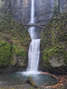 Waterfall surrounded by dark green landscape in Oregon