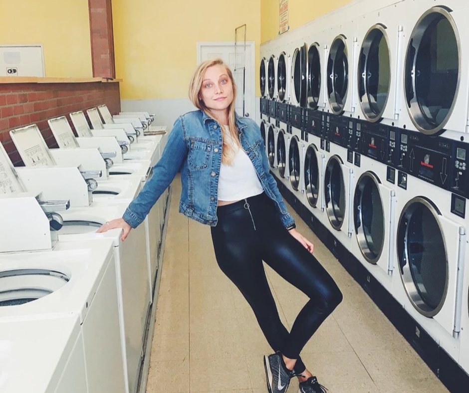 Nomad traveler doing laundry in a laundromat with homemade laundry detergent